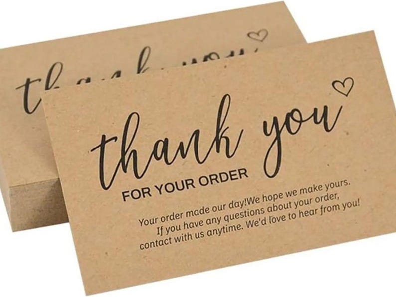 May include: A stack of rectangular light brown kraft paper cards featuring the black printed text thank you FOR YOUR ORDER and a small heart icon. The cards include additional printed text regarding customer service and order satisfaction.