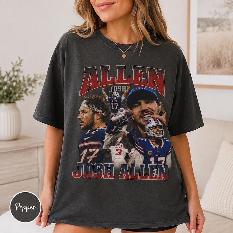 May include: A charcoal gray short-sleeve t-shirt featuring a vintage-style graphic print of football player Josh Allen. The design includes multiple action shots of the athlete in a blue and red uniform, with the text ALLEN and JOSH ALLEN.