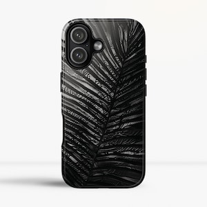May include: Black phone case with a textured palm leaf design. The case has a glossy finish and a black border. The camera lenses are visible at the top. The case is designed to protect the phone from scratches and damage.