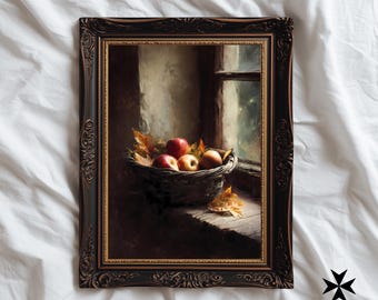 May include: A framed print depicting a still life of apples in a woven basket on a windowsill. The apples are red and yellow, with autumn leaves. The frame is dark brown with ornate detailing. The background shows a window with a blurred outdoor scene.