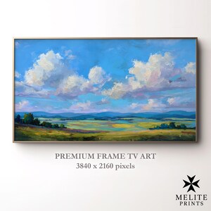 Pode incluir: Pintura de paisagem emoldurada com um céu vibrante cheio de nuvens brancas contra um fundo azul brilhante. A obra de arte retrata um campo de verde e amarelo com montanhas azuis distantes. O texto na parte inferior diz "PREMIUM FRAME TV ART" e "3840 x 2160 pixels".