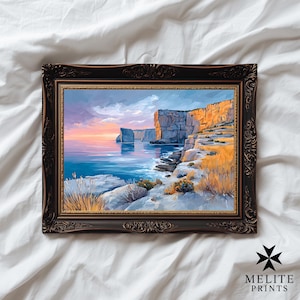 May include: A framed art print of a coastal landscape, showing cliffs, the sea, and a sunset. The artwork is in a dark, ornate frame, with the text "MELITE PRINTS" in the bottom right. The colours include blues, oranges, and yellows.