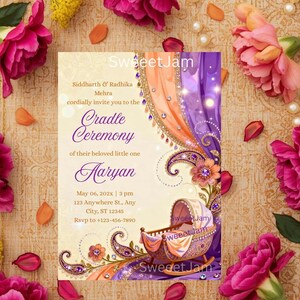 Könnte beinhalten: Eine Babyparty-Einladung mit floralem Design. Die Einladung enthält den Text "Cradle Ceremony" und "Aaryan". Die Einladung ist von rosa Blumen, Perlen und gelben Blumen umgeben.