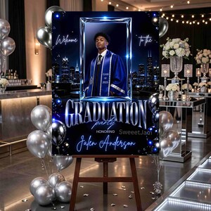 May include: A rectangular graduation party sign featuring a portrait of a graduate in a blue gown, set against a dark city skyline. The text reads Welcome to the Graduation party honoring Jalen Anderson, Class of 2025, in blue and silver.