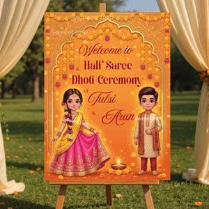 May include: An orange sign on an easel with the words "Welcome to Half Saree & Dhoti Ceremony of Tulsi & Arun." The sign features illustrations of a woman in a pink and yellow sari and a man in traditional attire.
