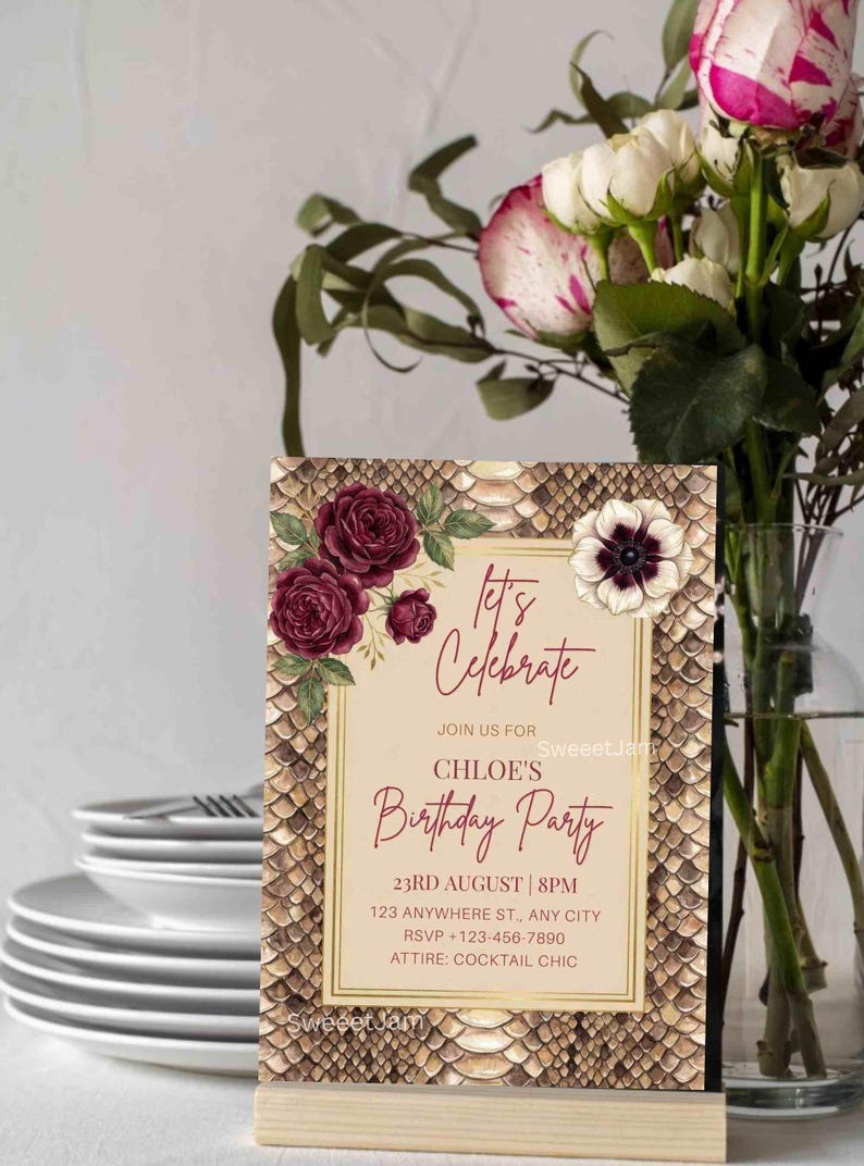 K&ouml;nnte beinhalten: Eine Geburtstagseinladung mit Schlangenmuster und floralen Akzenten. Auf der Einladung steht "Let's Celebrate" und enth&auml;lt Party-Details. Eine Vase mit Blumen und ein Stapel Teller befinden sich im Hintergrund.