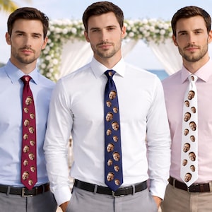 May include: Three men wearing dress shirts and ties. The ties are burgundy, navy blue, and white, each patterned with a repeating image of a face. The men are standing in front of a blurred outdoor background.