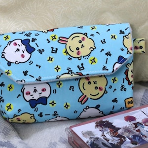 May include: A set of three ceramic mugs with a speckled, matte finish. Each mug features a different color: light blue, cream, and gray. The mugs have a simple, modern design and a comfortable handle.