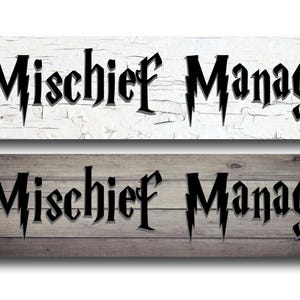 May include: Two rectangular wooden signs with the words "Mischief Manager" in a stylized font. One sign has a white, distressed background, and the other has a gray wood grain background. The text "USA MADE BY ME AT MY HOUSE" is in the left corner.
