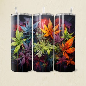 May include: Three stainless steel tumblers with a colorful abstract design of leaves. The leaves are in shades of green, yellow, orange, red, and purple. The tumblers are black and have a glossy finish.