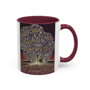 May include: White ceramic mug with a burgundy interior and handle. The mug features an illustration of a person pushing a large rock labeled with words like "Fear" and "Doubt". The text "The Leverage of Prayer" is at the bottom.