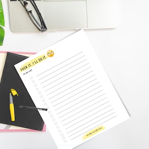 May include: A white to-do list notepad with the text "FUCK IT, I'LL DO IT" and an emoji. The notepad has lined spaces for tasks and the text "SHIT WON'T GET DONE ITSELF". A black pen and yellow highlighter are next to the notepad.