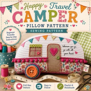 May include: A sewing pattern for a camper-shaped pillow titled Happy Travel Camper. The pillow features a white striped top, a floral bottom, a pink pom-pom trim, a heart-shaped door accent, and a large orange button wheel. Includes a measuring tape.