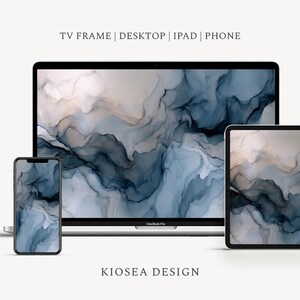 May include: A digital art design displayed on a phone, tablet, and laptop. The abstract design features flowing shades of blue, gray, and beige, with subtle gold accents. The text "TV FRAME | DESKTOP | IPAD | PHONE" and "KIOSEA DESIGN" are visible.