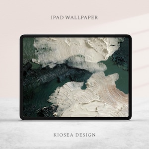 May include: An iPad displaying a digital abstract landscape wallpaper. The artwork features textured brushstrokes in shades of white, green, and brown. The text "IPAD WALLPAPER" and "KIOSEA DESIGN" are displayed above and below the screen.