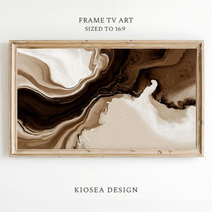 May include: Abstract art print for a TV screen, featuring a swirling design in shades of brown, beige, and white. The artwork is framed in a light brown wooden frame. Text at the top reads "FRAME TV ART SIZED TO 16:9" and at the bottom "KIOSEA DESIGN".