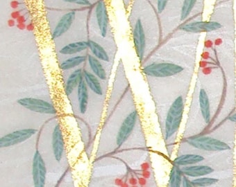 Initial letter painted gold with Rowan and Laurel leaves on silk paper