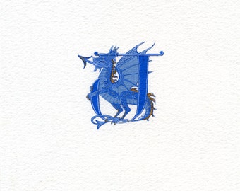 Letter handpainted with a blue and gold dragon.