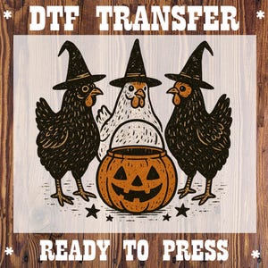 May include: DTF transfer featuring three chickens wearing witch hats, flanking a carved pumpkin. The chickens are black and white, with the pumpkin in orange. Text at the top reads "DTF TRANSFER" and at the bottom "READY TO PRESS".