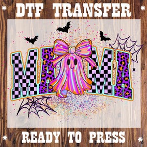 May include: DTF transfer featuring the word "MAMA" in a checkered and leopard print design, with a ghost wearing a bow. The design includes bats, spiderwebs, and the text "READY TO PRESS". The color palette includes purple, orange, and black.