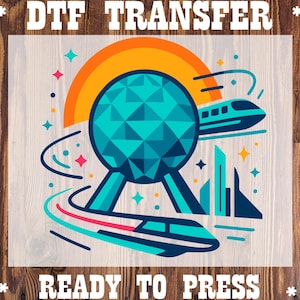 May include: DTF TRANSFER READY TO PRESS. A teal and orange graphic featuring a geometric sphere, a train, and a stylized sun. The design includes the text "DTF TRANSFER" at the top and "READY TO PRESS" at the bottom.