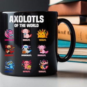 May include: Black ceramic mug featuring the text "AXOLOTLS OF THE WORLD" above colorful cartoon axolotl illustrations. Each axolotl is depicted in a different theme, such as a gamer, a musician, and a chef. The mug has a black handle.
