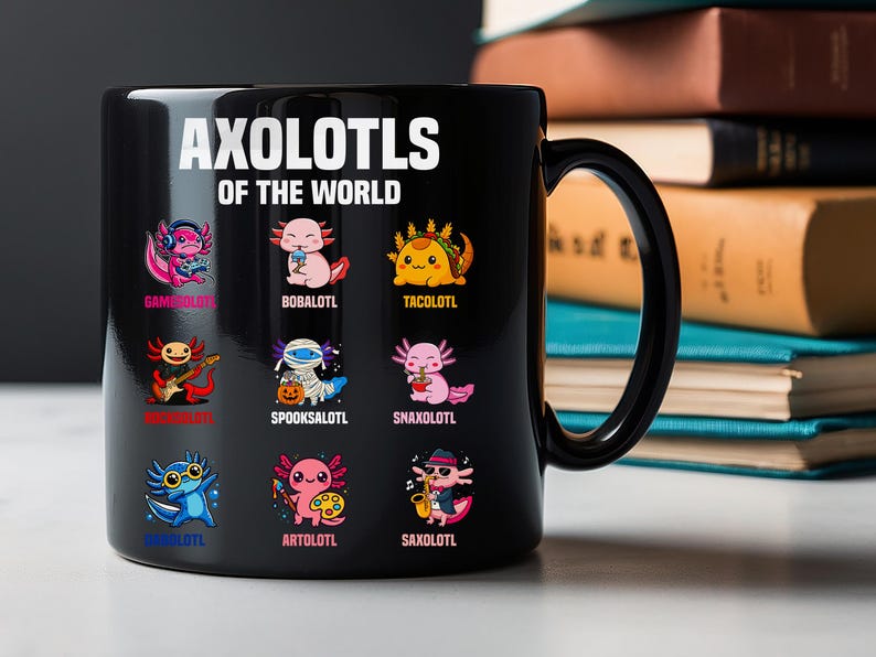 May include: Black ceramic mug featuring the text "AXOLOTLS OF THE WORLD" above colorful cartoon axolotl illustrations. Each axolotl is depicted in a different theme, such as a gamer, a musician, and a chef. The mug has a black handle.