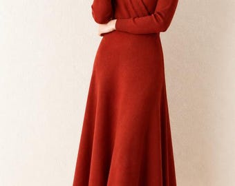 May include: A rust-colored long-sleeve midi dress featuring a wrap-style V-neckline and a flared skirt. The garment has a smooth knit texture and is displayed with the text Bellachicvibes and a heart symbol in the upper left corner.
