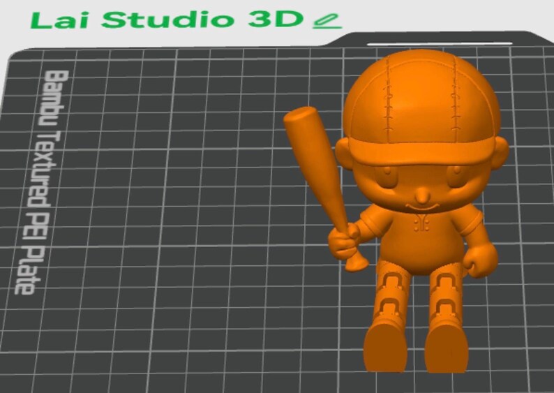May include: An orange 3D printed figurine of a character wearing a baseball cap and holding a baseball bat. The figure is positioned on a dark gray grid surface labeled Bambu Textured PEI Plate and Lai Studio 3D, featuring articulated legs.