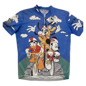 May include: A blue cycling jersey with a print of Mickey Mouse, Donald Duck, Goofy, and Pluto riding bicycles. The jersey has a zipper and the text "Look Ma" on the right sleeve.