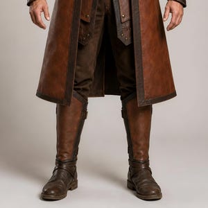 Front and back views of a handmade men’s brown leather Viking coat costume featuring a long medieval warrior design, wide cream fur shoulder collar, lace-up front, metal buckle closures, waist belt, dark leather trim, fitted sleeves, wrist guards, split coat hem, matching brown trousers, and tall leather boots. Rustic fantasy outfit inspired by Norse styles, ideal for Viking cosplay, Renaissance fairs, LARP events, Halloween costumes, stage performances, themed parties, and fantasy photoshoots.