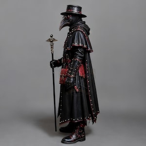 Black leather plague doctor costume coat with red leather detailing, layered shoulder armor, decorative rivets, straps, long sleeves, matching leather gloves and bracers. Gothic dark fantasy and steampunk inspired outfit for Halloween, cosplay, LARP, Renaissance fairs, festivals, photoshoots and costume parties. Handmade leather plague doctor outfit with customizable sizing. Hat, mask, bags, staff and other accessories are not included.
