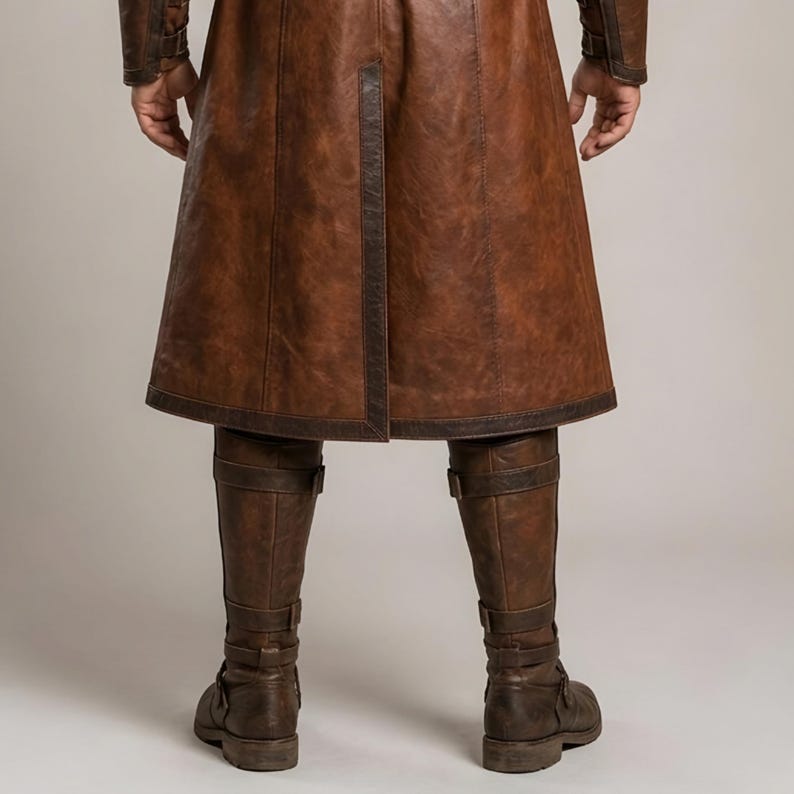 Front and back views of a handmade men’s brown leather Viking coat costume featuring a long medieval warrior design, wide cream fur shoulder collar, lace-up front, metal buckle closures, waist belt, dark leather trim, fitted sleeves, wrist guards, split coat hem, matching brown trousers, and tall leather boots. Rustic fantasy outfit inspired by Norse styles, ideal for Viking cosplay, Renaissance fairs, LARP events, Halloween costumes, stage performances, themed parties, and fantasy photoshoots.