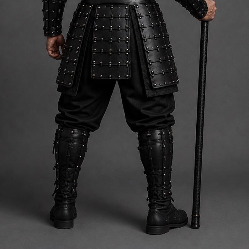Black samurai armor costume featuring a dark Japanese warrior design with layered leather chest armor, shoulder guards, arm bracers, waist belt, front panels and leg guards. Detailed metal rivets and adjustable straps create a strong medieval LARP and cosplay look. Handmade black leather warrior armor for Halloween, cosplay conventions, Renaissance fairs, photoshoots and fantasy events. Custom sizing is available. Helmet, stick, weapon, footwear and other accessories are not included in photos.