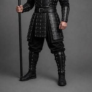 Black samurai armor costume featuring a dark Japanese warrior design with layered leather chest armor, shoulder guards, arm bracers, waist belt, front panels and leg guards. Detailed metal rivets and adjustable straps create a strong medieval LARP and cosplay look. Handmade black leather warrior armor for Halloween, cosplay conventions, Renaissance fairs, photoshoots and fantasy events. Custom sizing is available. Helmet, stick, weapon, footwear and other accessories are not included in photos.