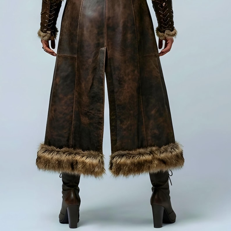 Women’s brown Viking leather fur coat costume featuring a dramatic fur-trimmed collar, long medieval warrior silhouette, fitted waist, front metal closures, leather belt, matching pants, wrist guards, and lace-up boots. Handmade Shieldmaiden-inspired outfit for Halloween, Viking cosplay, LARP events, Renaissance fairs, medieval festivals, fantasy conventions, Norse-themed parties, winter events, stage performances, warrior photoshoots, and custom made-to-measure costume styling for cosplay fans