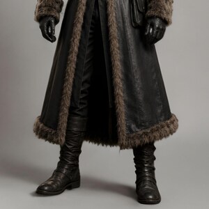 Black leather plague doctor coat with a dramatic fur-trimmed hood, shoulders, cuffs, front edges, and hem. Long medieval-inspired silhouette with lace-up front, wide adjustable leather belt, fitted sleeves, and dark gothic styling. Ideal for plague doctor cosplay, Halloween costume, LARP, Renaissance fairs, medieval festivals, fantasy events, gothic photoshoots, theatrical performances, and themed parties. Handmade leather costume coat with custom sizing available for a personalized fit.