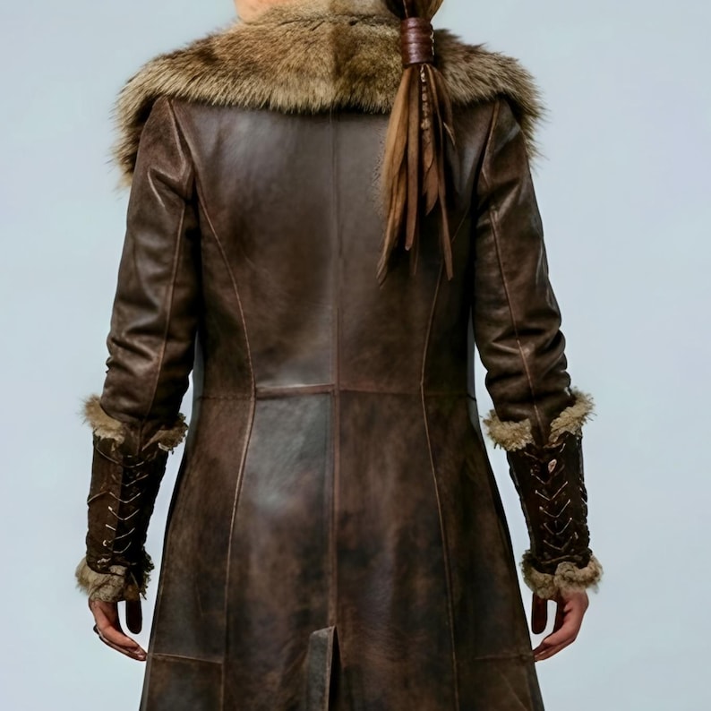 Women’s brown Viking leather fur coat costume featuring a dramatic fur-trimmed collar, long medieval warrior silhouette, fitted waist, front metal closures, leather belt, matching pants, wrist guards, and lace-up boots. Handmade Shieldmaiden-inspired outfit for Halloween, Viking cosplay, LARP events, Renaissance fairs, medieval festivals, fantasy conventions, Norse-themed parties, winter events, stage performances, warrior photoshoots, and custom made-to-measure costume styling for cosplay fans