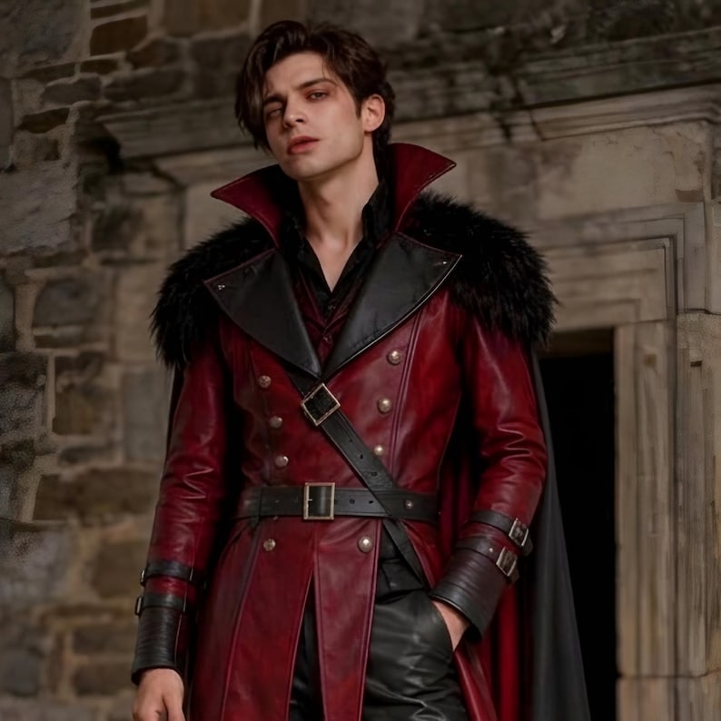 Men’s red and black Gothic vampire leather coat featuring a high standing collar, black fur-trimmed shoulders, double-breasted button detailing, wide waist belt, cross-body leather strap, long sleeves, and a dramatic floor-length silhouette. The dark Victorian-inspired design creates a Vampire Lord look ideal for Halloween, gothic cosplay, LARP, Renaissance fairs, masquerade events, fantasy conventions, stage performances, costume parties, and themed photoshoots.