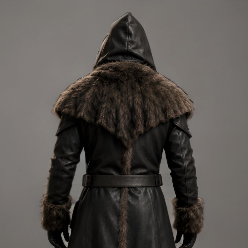Black leather plague doctor coat with a dramatic fur-trimmed hood, shoulders, cuffs, front edges, and hem. Long medieval-inspired silhouette with lace-up front, wide adjustable leather belt, fitted sleeves, and dark gothic styling. Ideal for plague doctor cosplay, Halloween costume, LARP, Renaissance fairs, medieval festivals, fantasy events, gothic photoshoots, theatrical performances, and themed parties. Handmade leather costume coat with custom sizing available for a personalized fit.