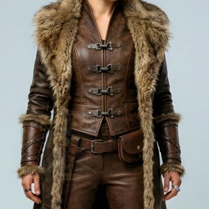 Women’s brown Viking leather fur coat costume featuring a dramatic fur-trimmed collar, long medieval warrior silhouette, fitted waist, front metal closures, leather belt, matching pants, wrist guards, and lace-up boots. Handmade Shieldmaiden-inspired outfit for Halloween, Viking cosplay, LARP events, Renaissance fairs, medieval festivals, fantasy conventions, Norse-themed parties, winter events, stage performances, warrior photoshoots, and custom made-to-measure costume styling for cosplay fans
