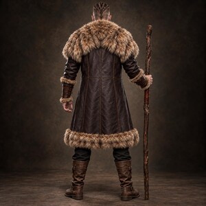 Men’s Viking warrior leather coat in rugged brown with a long medieval silhouette, wide synthetic faux fur collar, fur-trimmed cuffs and hem, front leather straps, metal buckle closures, and detailed stitched panels. The costume is styled over dark clothing for a bold Norse warrior look. Ideal for Viking cosplay, medieval LARP, Renaissance fairs, Halloween costumes, fantasy events, themed parties, stage performances, conventions, and dramatic medieval photoshoots.