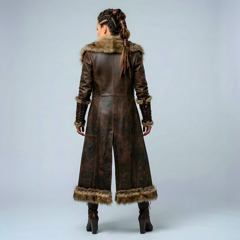 Women’s brown Viking leather fur coat costume featuring a dramatic fur-trimmed collar, long medieval warrior silhouette, fitted waist, front metal closures, leather belt, matching pants, wrist guards, and lace-up boots. Handmade Shieldmaiden-inspired outfit for Halloween, Viking cosplay, LARP events, Renaissance fairs, medieval festivals, fantasy conventions, Norse-themed parties, winter events, stage performances, warrior photoshoots, and custom made-to-measure costume styling for cosplay fans