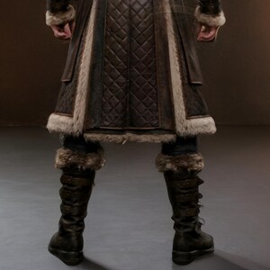 Brown leather Viking fur coat with a long medieval design, wide waist belt, layered leather panels, fur-trimmed collar, front edges and cuffs, and matching leather leg armor. Rugged Norse-inspired cosplay outfit for men, suitable for Halloween, LARP events, Viking cosplay, Renaissance fairs, medieval festivals, fantasy conventions, themed parties and photoshoots. Handmade with custom sizing and design options available.