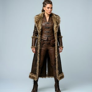 Women’s brown Viking leather fur coat costume featuring a dramatic fur-trimmed collar, long medieval warrior silhouette, fitted waist, front metal closures, leather belt, matching pants, wrist guards, and lace-up boots. Handmade Shieldmaiden-inspired outfit for Halloween, Viking cosplay, LARP events, Renaissance fairs, medieval festivals, fantasy conventions, Norse-themed parties, winter events, stage performances, warrior photoshoots, and custom made-to-measure costume styling for cosplay fans