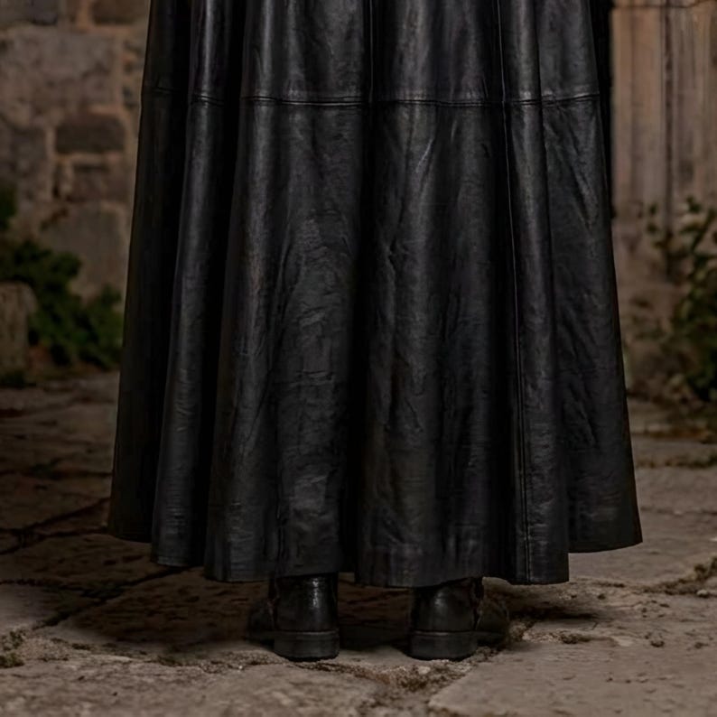 Men’s red and black Gothic vampire leather coat featuring a high standing collar, black fur-trimmed shoulders, double-breasted button detailing, wide waist belt, cross-body leather strap, long sleeves, and a dramatic floor-length silhouette. The dark Victorian-inspired design creates a Vampire Lord look ideal for Halloween, gothic cosplay, LARP, Renaissance fairs, masquerade events, fantasy conventions, stage performances, costume parties, and themed photoshoots.