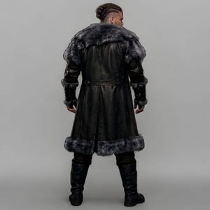 Black leather Viking armor costume with a long fur-trimmed medieval coat, sleeveless inner armor vest, layered leather panels, wide waist belt, fur-trimmed shoulders, long sleeves, adjustable straps, and matching leather leg armor. Rugged Norse-inspired outfit for men, ideal for Halloween, Viking cosplay, LARP, Renaissance fairs, medieval festivals, fantasy conventions, winter events, themed parties, and photoshoots. Handmade with custom sizing and customization options.
