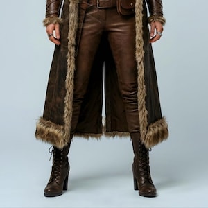 Women’s brown Viking leather fur coat costume featuring a dramatic fur-trimmed collar, long medieval warrior silhouette, fitted waist, front metal closures, leather belt, matching pants, wrist guards, and lace-up boots. Handmade Shieldmaiden-inspired outfit for Halloween, Viking cosplay, LARP events, Renaissance fairs, medieval festivals, fantasy conventions, Norse-themed parties, winter events, stage performances, warrior photoshoots, and custom made-to-measure costume styling for cosplay fans
