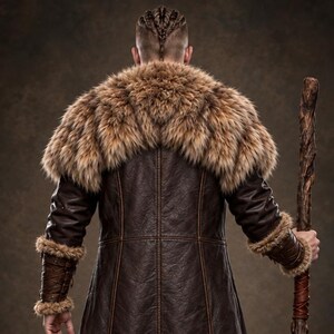 Men’s Viking warrior leather coat in rugged brown with a long medieval silhouette, wide synthetic faux fur collar, fur-trimmed cuffs and hem, front leather straps, metal buckle closures, and detailed stitched panels. The costume is styled over dark clothing for a bold Norse warrior look. Ideal for Viking cosplay, medieval LARP, Renaissance fairs, Halloween costumes, fantasy events, themed parties, stage performances, conventions, and dramatic medieval photoshoots.