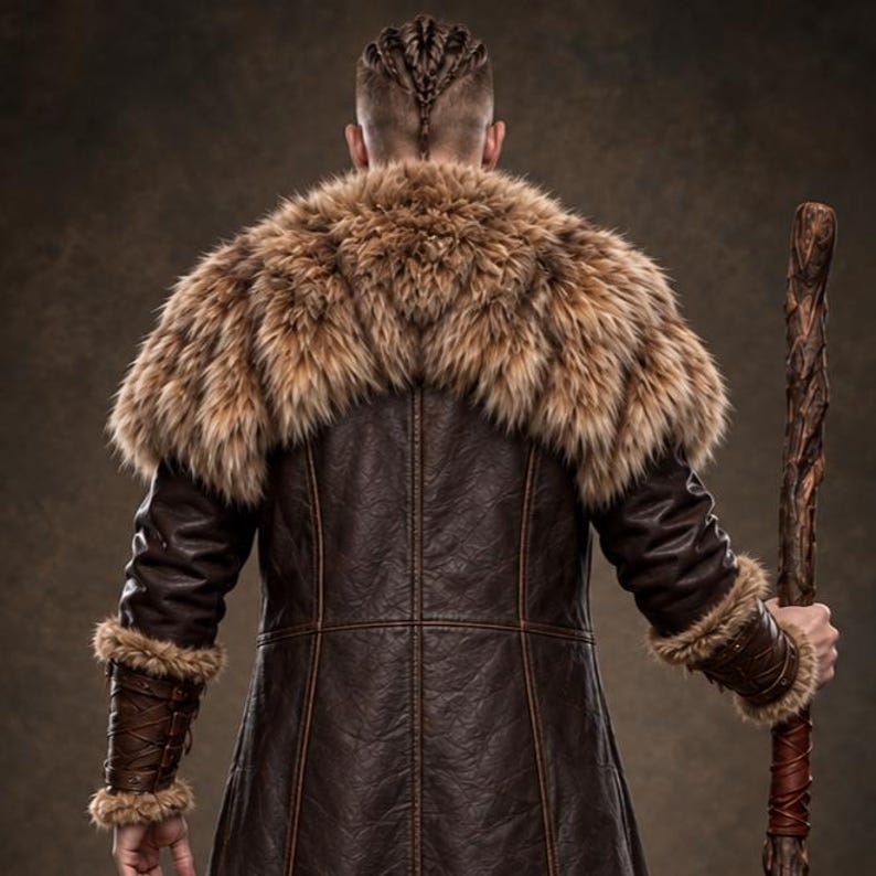 Men’s Viking warrior leather coat in rugged brown with a long medieval silhouette, wide synthetic faux fur collar, fur-trimmed cuffs and hem, front leather straps, metal buckle closures, and detailed stitched panels. The costume is styled over dark clothing for a bold Norse warrior look. Ideal for Viking cosplay, medieval LARP, Renaissance fairs, Halloween costumes, fantasy events, themed parties, stage performances, conventions, and dramatic medieval photoshoots.
